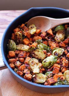 a pan filled with brussel sprouts and sweet potatoes