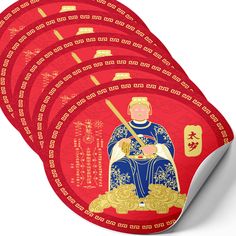 four red and gold coasters with an image of a man sitting on a throne