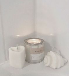 a candle and some white objects in a room