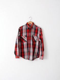 A classic vintage JC Penney Big Mac plaid work shirt. The flannel cotton shirt features a bold red, black, and white print. Bias cut patch pockets detail the chest. It buttons closed. • JC Penney Big Mac shirt• 100% Cotton• plaid flannel• pockets on chest• button down• button cuffsCONDITIONIn good condition with wear consistent with age and use. MARKED SIZE:  MMEASUREMENTSBust:          22.5" (45)     ...       57.2 cm (114.3)Length:      27.5"            ...        69.9 cmSleeves:    32.5" Buckskin Dress, Flannel Shirt Outfit, Vintage Flannel, Chunky Knit Cardigan, Big Mac, Black And White Print, Native American Fashion, Work Shirt, Plaid Flannel Shirt