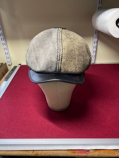 This is a leather newsboy hat.   There are two variations to this hat:  a six-paneled option and an 8-paneled option.  The difference is how the crown sits on the brim.  The six-sided version stands taller while the 8-paneled rests on the brim. Please let me know in the comments at the time of purchase which of these options you want. Please refer to the sizing chart in the pictures for your hat size. Multi-colored options are available for the hat.  If you would like the panels different colors Vintage Hat With Leather Sweatband And Short Brim, Adjustable Leather Baseball Cap With Short Brim, Luxury Adjustable Six-panel Hat, Vintage Leather Hat With Leather Sweatband, Leather Newsboy Hat, Retro Leather Cap, Classic Leather Visor Hat, Adjustable Leather Flat Cap Baseball Cap, Adjustable Leather Flat Cap