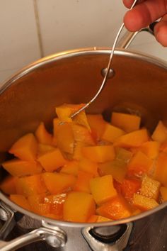 a person is stirring some food in a pot