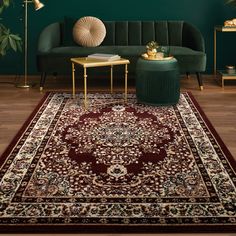 a living room with green walls and a red rug on the floor next to a couch