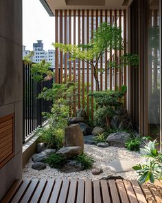 a small garden with rocks and trees in the center, surrounded by wooden slats