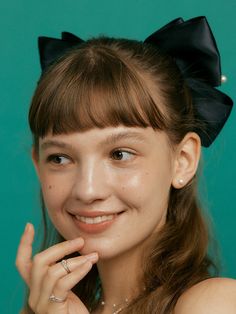 a woman with a black bow on her head