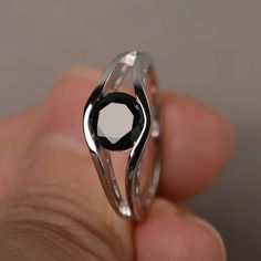 This is a gorgeous handmade creation. Its beauty is its simplicity & Elegance. The 7*7mm round shape faceted natural black spinel is crafted in solid sterling silver and with rhodium plated. All item is sent in a beautiful gift box If you have any idea of design your ring,pls contact me directly. You can realize more lovely stuff clicking the link https://www.etsy.com/shop/knightjewelry?refshopsection_shophome_leftnav Please leave the correct address and you phone number for delivering succe Black Gemstone Ring, Dark Rings, Diamond Skull, Black Spinel Ring, August Birthstone Ring, Garnet Ring Silver, Diamond Engagement Band, Engagement Rings Couple, Green Amethyst Ring