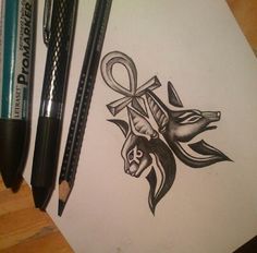 a drawing of an animal with a cross on it's head and some pencils next to it