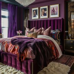 a bedroom with purple walls and bed in the center, two pictures on the wall