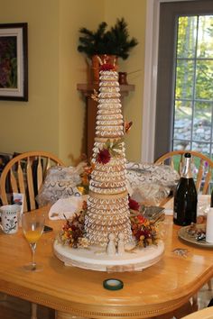 a christmas tree made out of cookies sitting on top of a table next to wine bottles