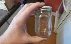 a person holding a mason jar in their hand