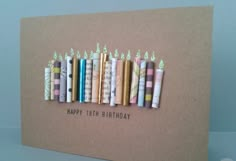 a birthday card with candles on top of it and the words happy birthday written in small letters