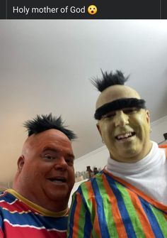 two men dressed up as clowns with fake hair and piercings on their heads