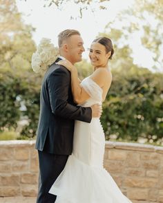 a bride and groom standing next to each other