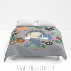 a bed with an animal themed comforter and pillow cases on it's sides