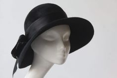 Pandora Felt Cloche Hat. Perfectly proportioned and made in butter soft black velour felt The hat has flattering wide brim contours. An essential stylish cloche hat with pure silk ribbon band and feather detail. Classic and nostlagic, easy to wear and accessorize, simply sophisticated, irresitable in any colour and guaranteed to transform your everyday and special occasions wardrobe.  COLOUR: Black YOUR SIZE S = 21½ M = 22 - 22½ L = 22½ - 23" XL= 23 - 23½ Place a tape measure on your forehead ju Elegant Felt Mini Hat With Short Brim, Classic Wide Brim Cloche Hat For Wedding, Elegant Cloche Felt Hat For Evening, Brimmed Fur Felt Hat For Party, Elegant Brimmed Fur Felt Hat, Elegant Felt Hat For Party, Adjustable Cloche Felt Hat For Evening, Elegant Adjustable Felt Top Hat, Party Wide Brim Fur Felt Hat