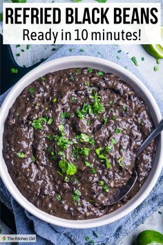 Refried black beans in white bowl with serving spoon. Title: Refried Black beans: Ready in 10 minutes!