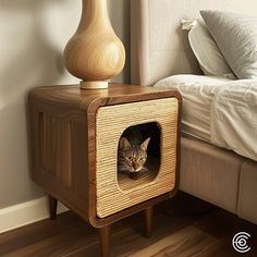 a cat is sitting in an empty litter box on the floor next to a bed