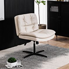 a white chair sitting on top of a wooden floor next to a black and white rug