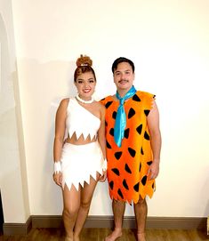 a man and woman dressed in costumes standing next to each other