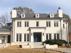 a large white house sitting on top of a hill