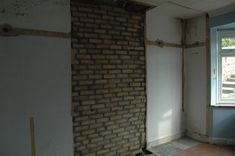 an empty room with brick walls and no one in the room or there is a window