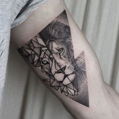 a man's arm with a tattoo on it and an image of a lion