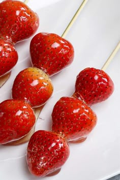 strawberries are arranged in the shape of hearts on a plate