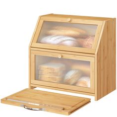 a wooden box with some bread in it and a cutting board on the bottom side