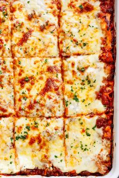 a square casserole dish filled with cheese and sauce