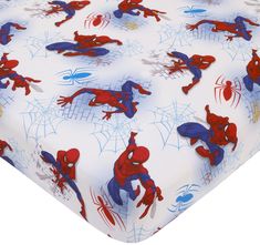 a spiderman print sheet set on top of a bed