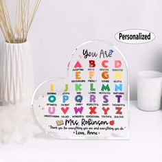 a heart shaped acrylic sign with the words you are abc, q, m, person and l