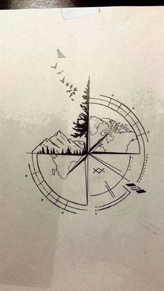 a compass with trees and birds on it