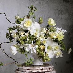 a vase filled with white flowers on top of a table