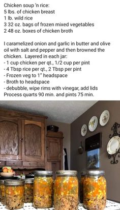 four jars filled with food sitting on top of a counter next to a wooden cabinet