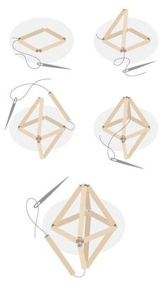 four pieces of wood are arranged in the shape of an origami kite with strings