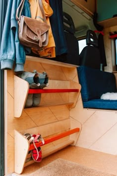 the inside of a van with shoes and bags on it's shelves, next to a purse