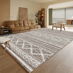 a living room filled with furniture and a large rug