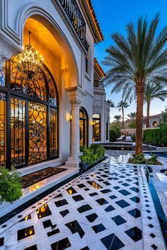 an elegant house with black and white checkered flooring in front of the pool