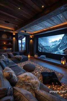 a living room with couches and a large screen