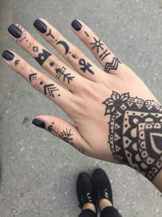 a woman's hand with tattoos on it