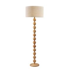 a wooden floor lamp with a white shade on it's base and a beige linen lampshade