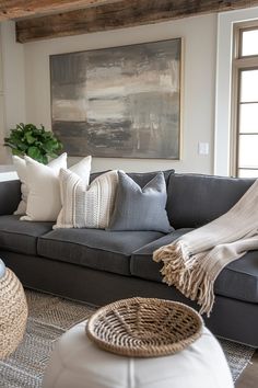 a living room filled with lots of furniture and pillows on top of a gray couch