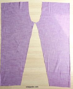 the back side of a pair of purple pants on top of a wooden floor with one piece cut out