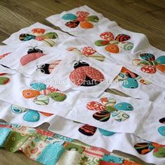 several pieces of fabric are laid out on the floor to be used as placemats