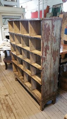 an old bookcase is sitting on the floor