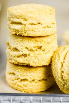 a stack of yellow cookies sitting on top of a metal pan next to each other