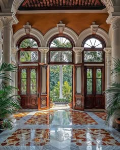 an ornate entry way with large windows and doors