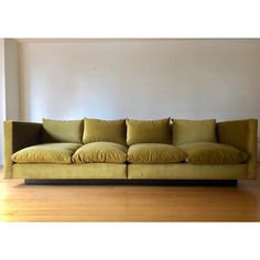 a yellow couch sitting on top of a hard wood floor