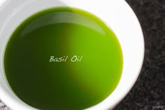 a bowl filled with green liquid on top of a table