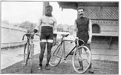 two men standing next to each other with bicycles